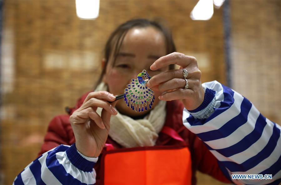 People busy making silver handicrafts for Spring Festival in Guizhou